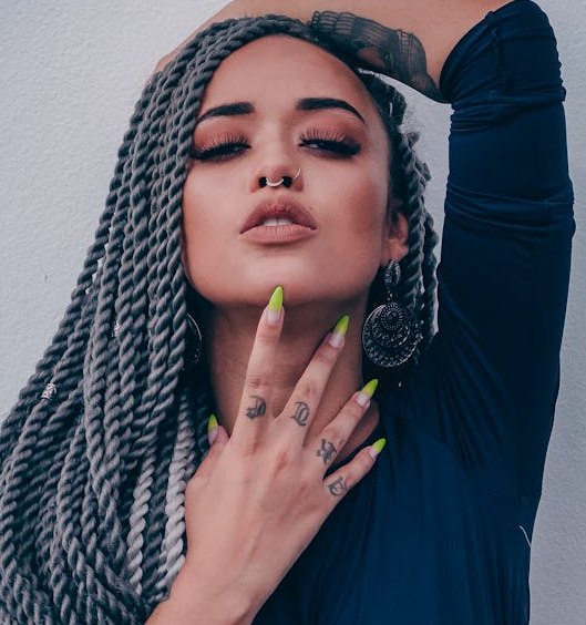 Stylish woman with gray Senegalese twist braids, bold earrings, and neon nails – Braided Aura Nainital