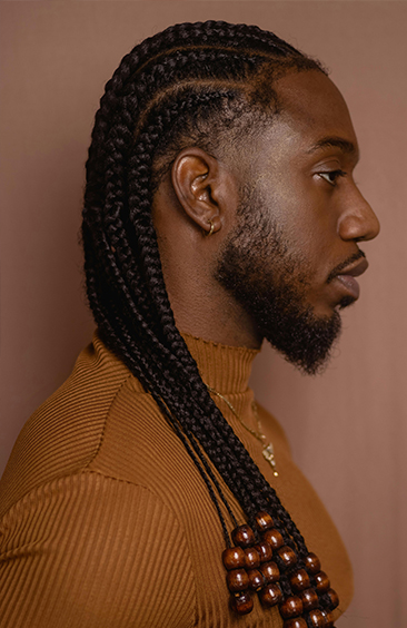 Man with long cornrow braids decorated with wooden beads – Braided Aura Nainital