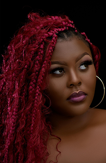 Woman with long burgundy braids and curls – Braided Aura Nainital