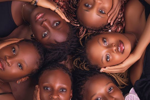 Group of women with braided hairstyles lying in a circle – Braided Aura Nainital